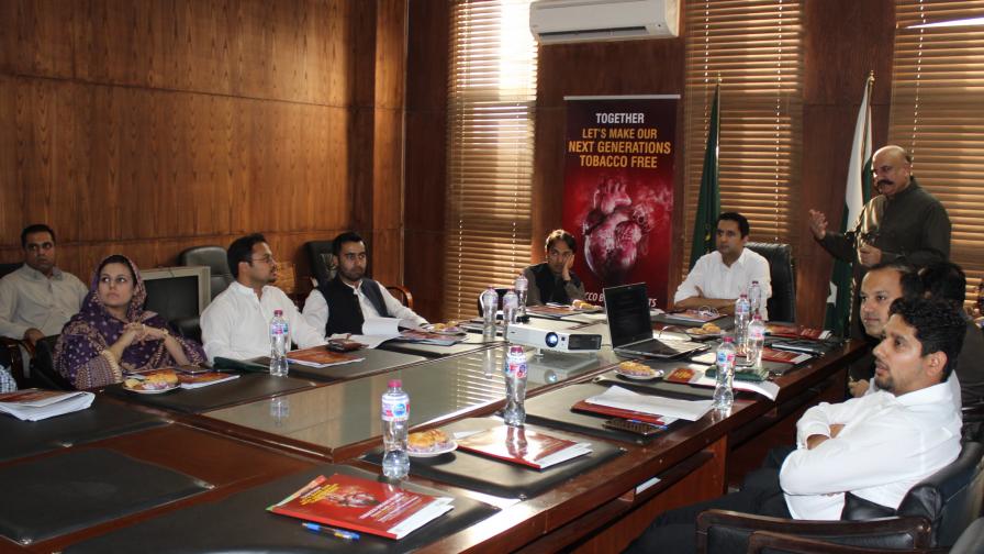 A large group meet around a table